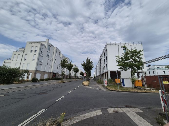 Wohnung im Bau, stadtnah im Hafenquartier Graf Bismark mit Balkon am Yachthafen/Kanal für 2 Personen – Hausansicht mit Straßenzug