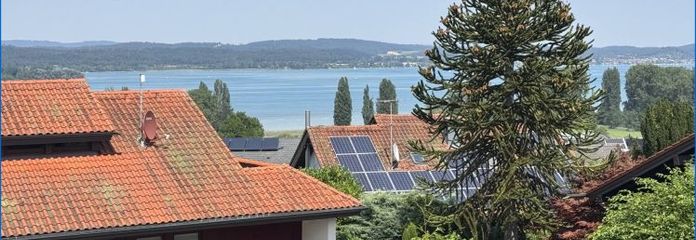 Straordinario appartamento mansardato di 4,5 locali con splendida vista sul lago, terrazze sul tetto e garage!
