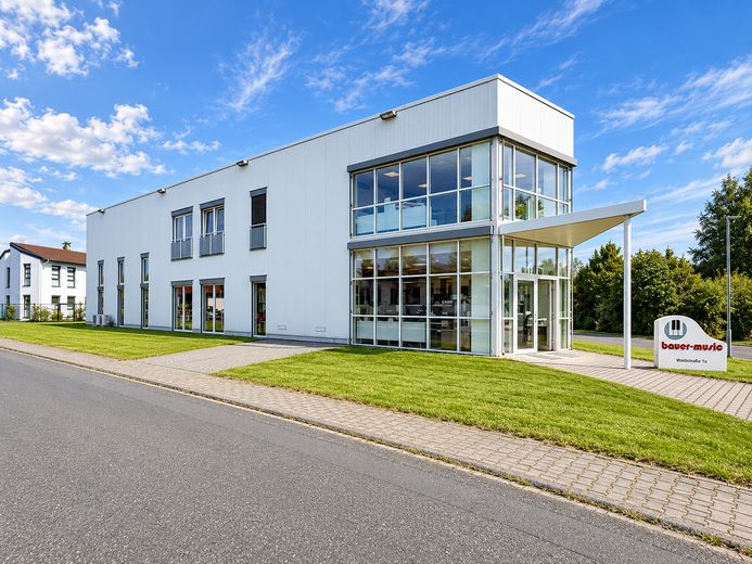 Immobile commerciale polivalente con showroom, capannone e unità abitativa a Heusenstamm – Seitenansicht mit Eingang