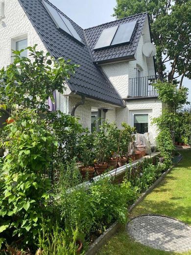 Einfamilienhaus in kühlem Garten – Gartenansicht