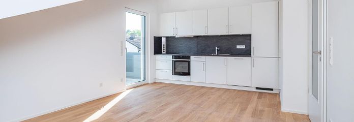Ready to move in + commission-free: Newly built top-floor apartment with balcony + fitted kitchen | Parsdorf near Munich – Wohnzimmer mit EBK