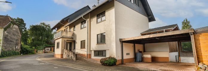 Großes Wohnhaus zur Nutzung als ZFH, Mehrparteivermietimmobilie oder Mehrgenerationenhaus – Vorderansicht mit Carport