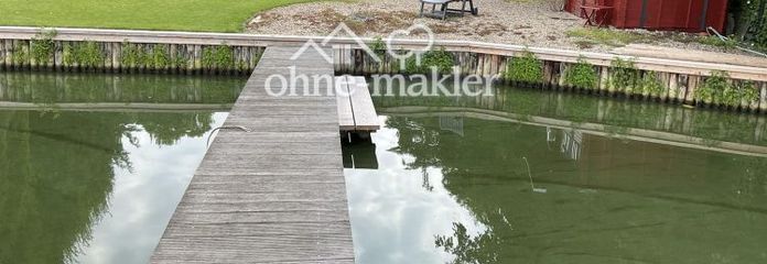Waterfront property with bungalow and boat dock.