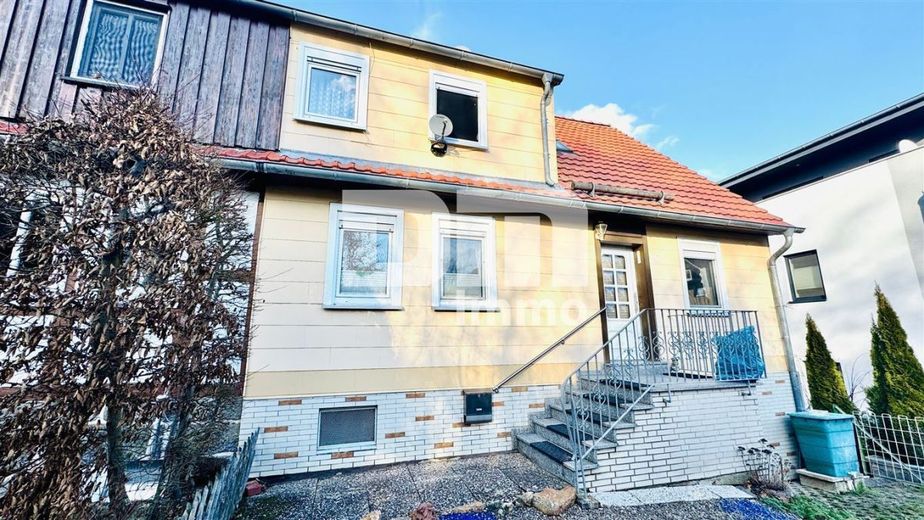 Schöne Doppelhaushälfte mit Nebengebäude, Garage und angelegtem Gartenbereich – Frontansicht