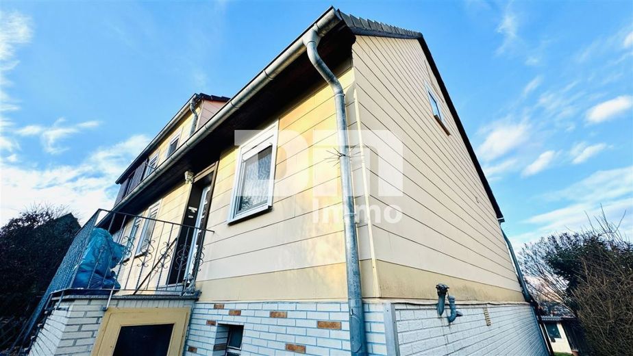 Schöne Doppelhaushälfte mit Nebengebäude, Garage und angelegtem Gartenbereich – Seitenansicht