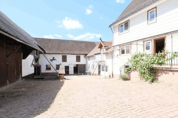 Residential house, large garage, former horse breeding with 9 box stalls, 2 barns, storage hay lofts in the three-sided courtyard..