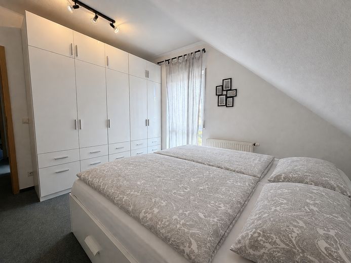 Attraktive 3-Zimmer-DG-Wohnung mit Balkon, TG & Stellplatz in Mühlhausen-Rettigheim – Schlafzimmer
