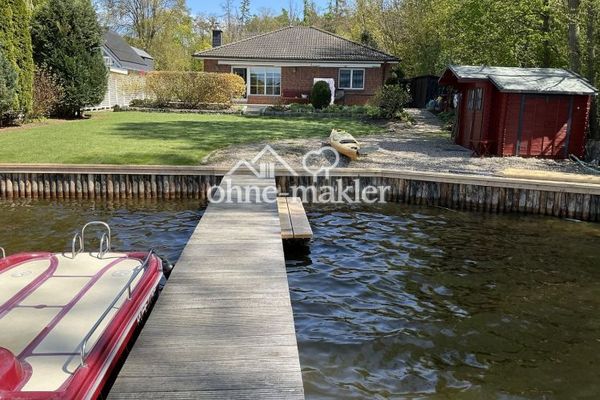 Waterfront property with bungalow and boat dock.