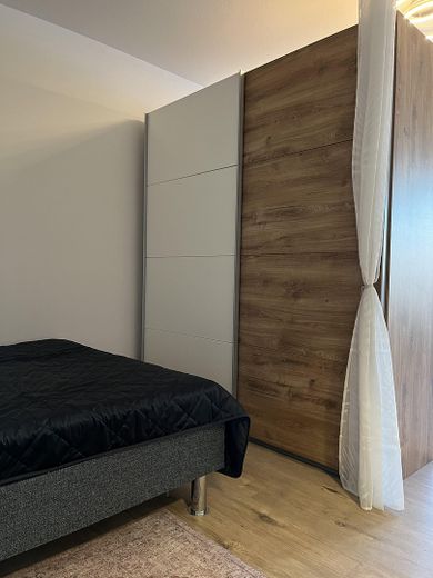 Möbliertes Apartment im Münchner Süden mit Pool, Grünanlage und Fernblick – Schlafbereich m großem Schrank