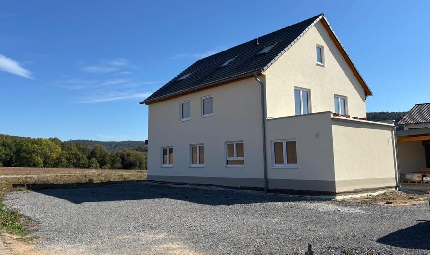 Appartamento con 3 locali al piano terra, vista mozzafiato, ampia terrazza + giardino – Blick Parkfläche auf Haus 