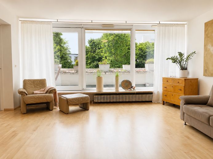 Großzügige Dachterrassenwohnung mit zusätzlichem Balkon in Haar – Blick vom WZ in die Baumwipfel