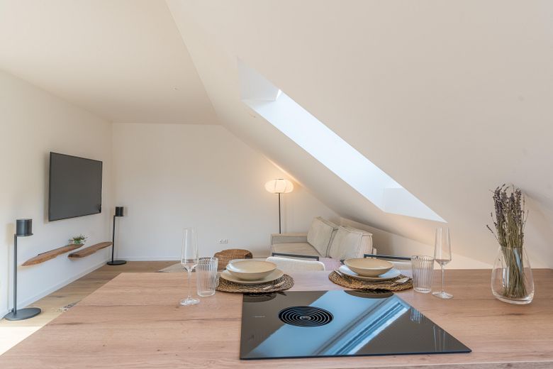 Langenbach | Nuovo bilocale mansardato con cucina BORA e ampio balcone soleggiato – Blick zum Wohnbereich