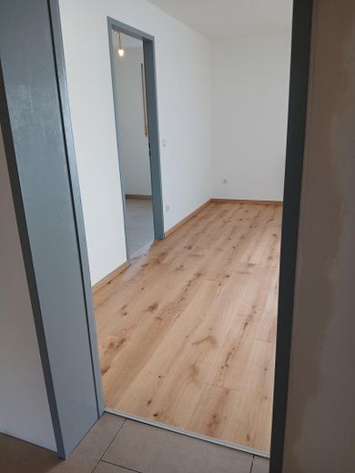 Affascinante bilocale con balcone e posto auto in autorimessa interrata — Regensburg-Galgenberg – Vorraum-Wohnzimmer