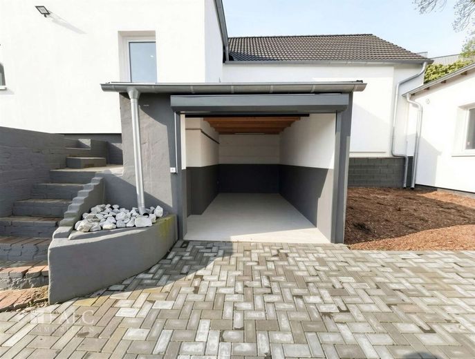 Attraktives Gesamtpaket: modernes Wohnhaus, vermietete Halle &amp; Baupotenzial – Garage