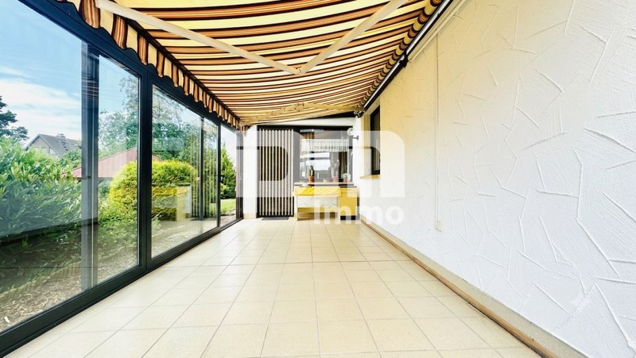 Solider Familien-Bungalow mit großem Potenzial in ruhiger Lage mit Wintergarten und Garage – EG Wintergarten / Zugang Gartenbereich