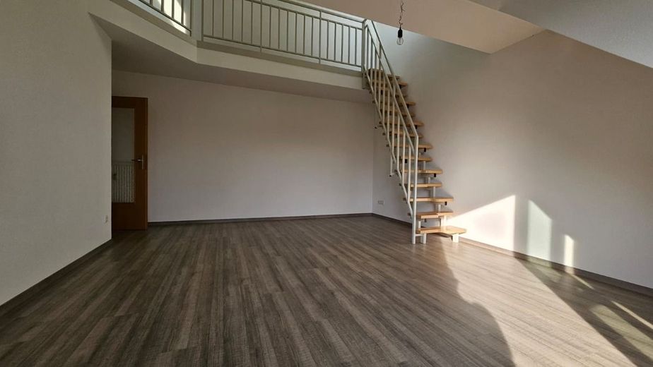 Helle 2-Zimmer-Dachgeschosswohnung mit Galerie und Balkon in ruhiger Lage in Hallbergmoos – Blick vom Balkon ins Wohnzimmer